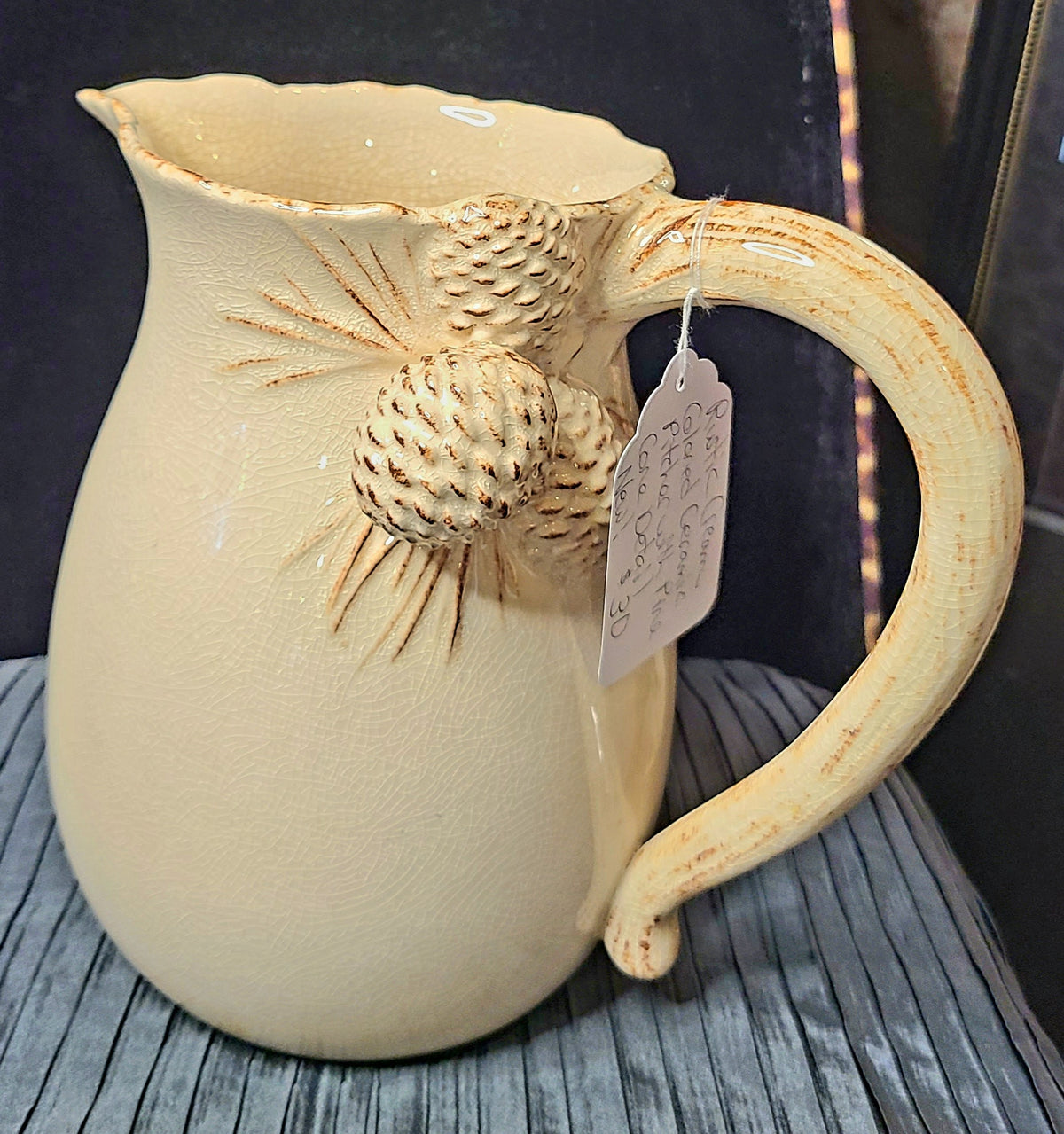 Rustic Cream Colored Ceramic Pitcher with Pine Cone Detail